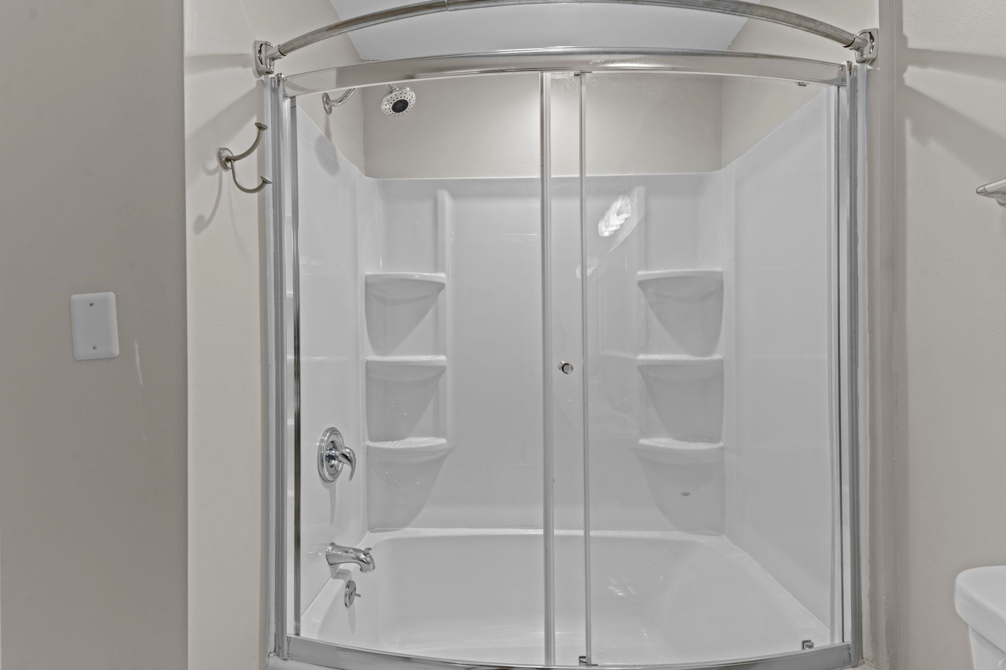 409 Husketh Road Youngsville, NC 27596 - Photo 20 of 29 a bathroom with a glass shower door