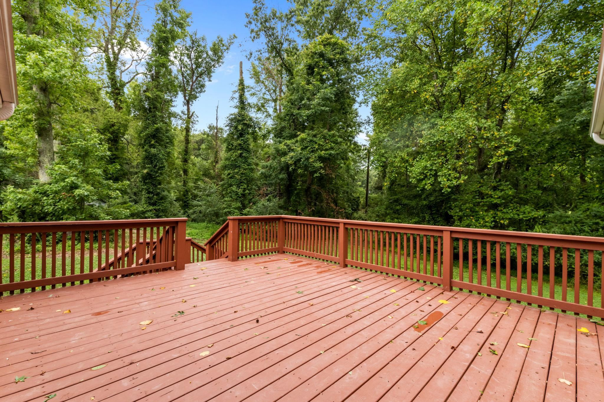 409 Husketh Road Youngsville, NC 27596 - Photo 24 of 29 a balcony with wooden floor and trees