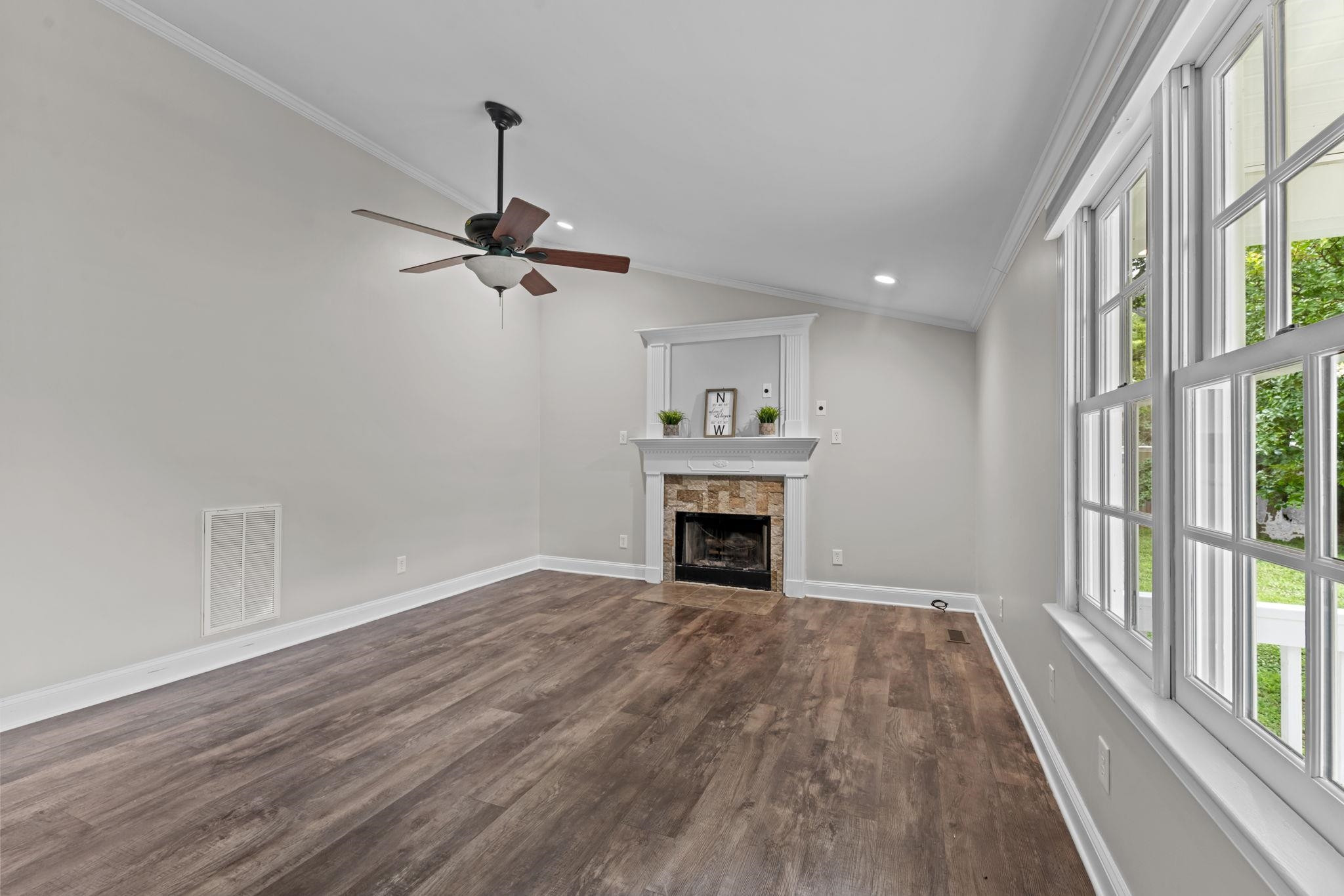409 Husketh Road Youngsville, NC 27596 - Photo 4 of 29 a view of an empty room with a fireplace and a window