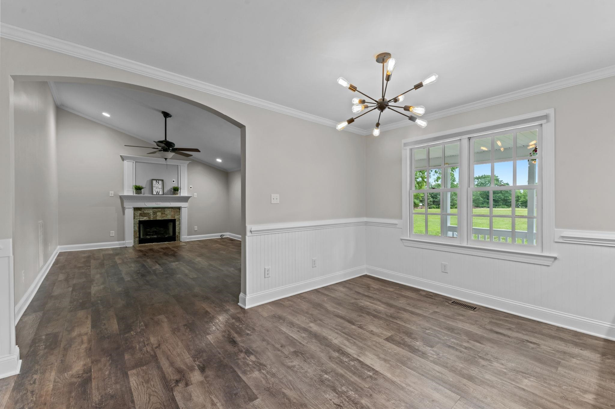 409 Husketh Road Youngsville, NC 27596 - Photo 6 of 29 a view of a room with a ceiling fan window and a fireplace