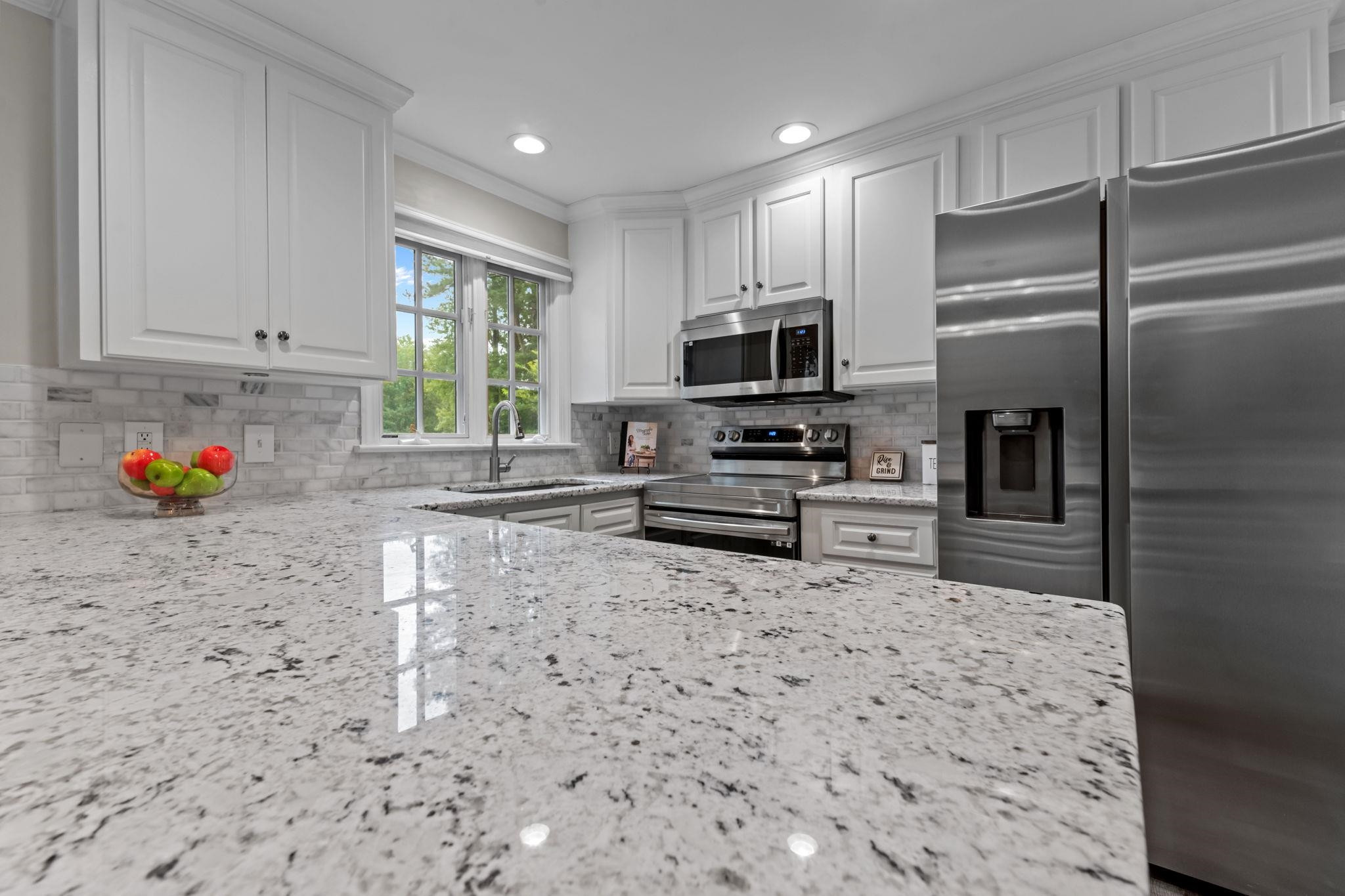 409 Husketh Road Youngsville, NC 27596 - Photo 9 of 29 a kitchen with stainless steel appliances a refrigerator sink microwave and cabinets