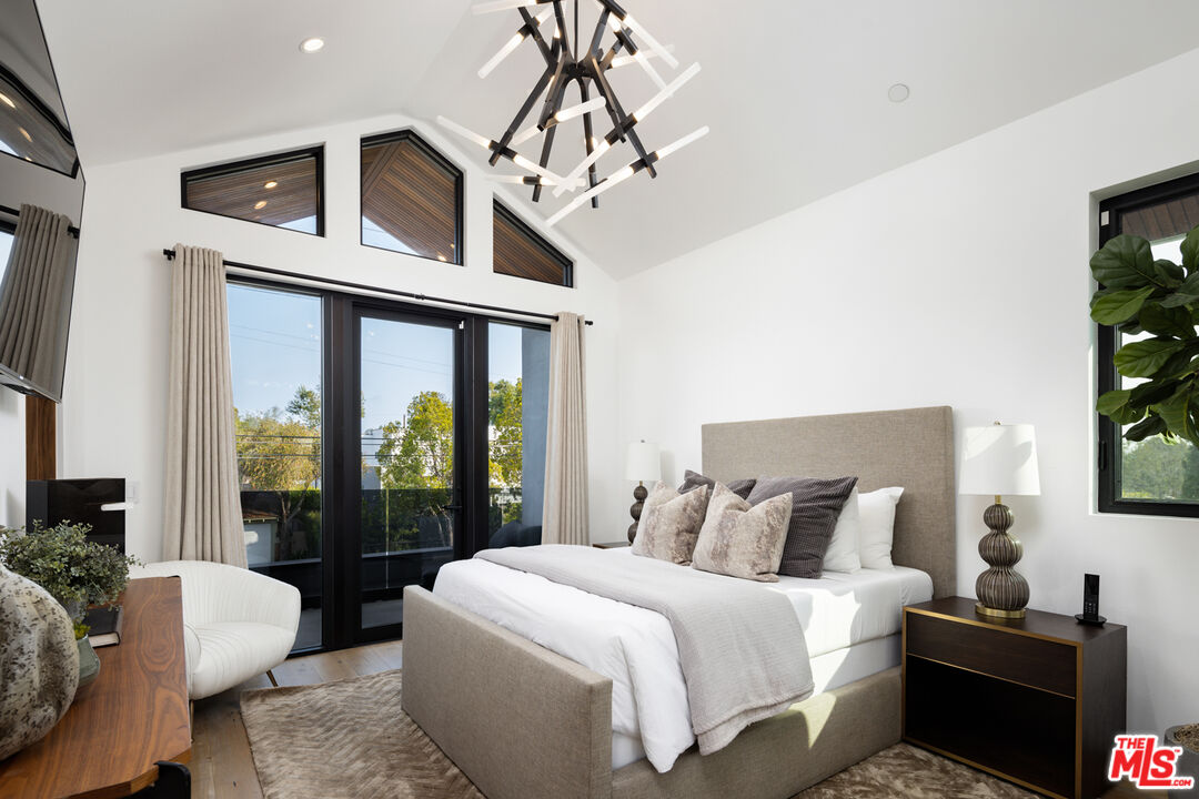 1371 Palms Boulevard Venice, CA 90291 - Photo 17 of 21 a spacious bedroom with a bed and a chandelier