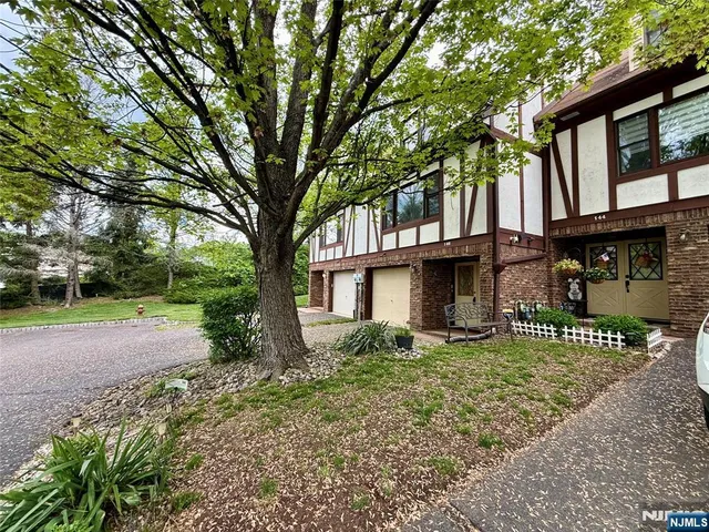 a view of a house with a tree in the background