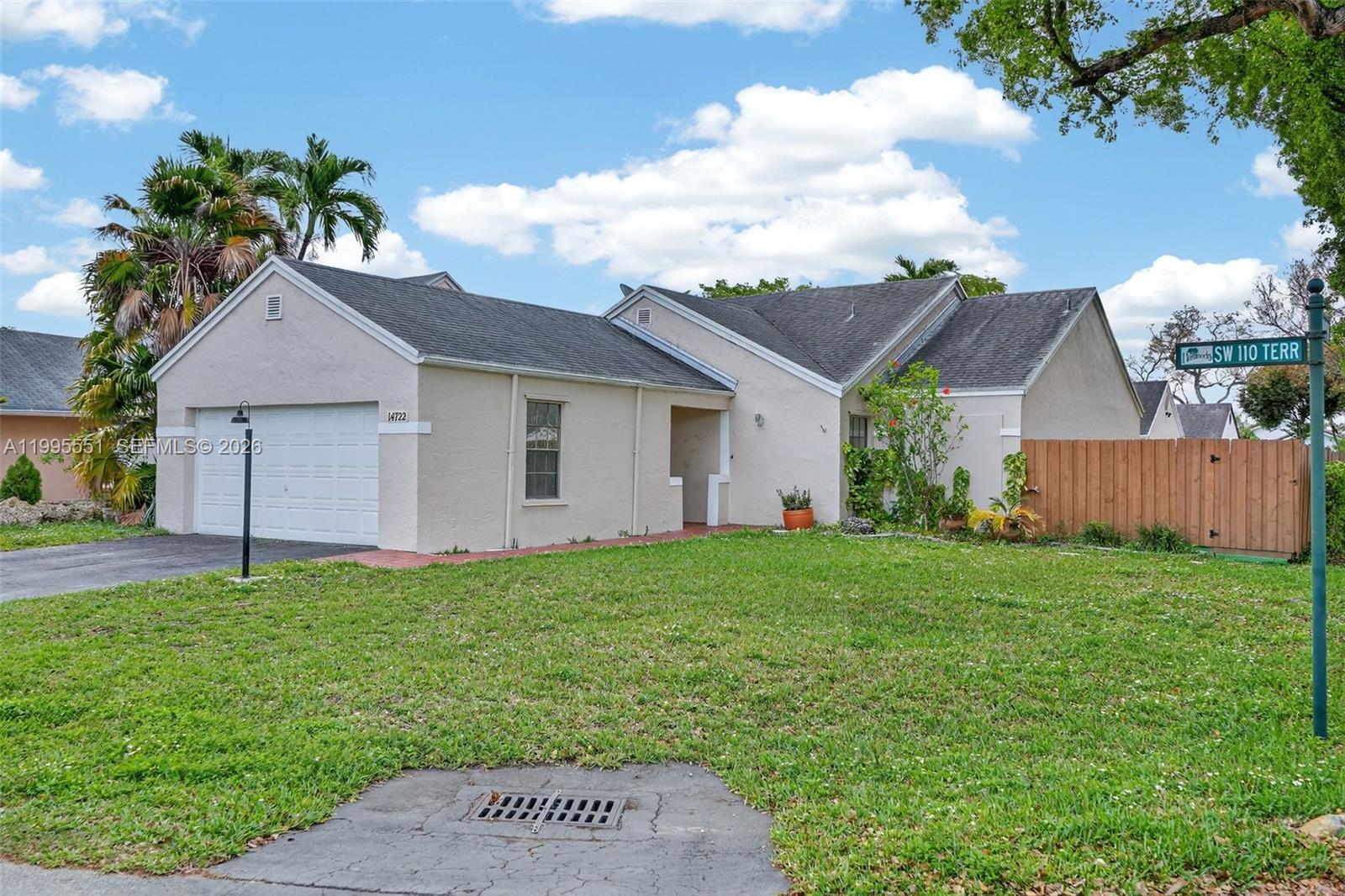 14722 Southwest 110th Terrace Miami, FL 33196 - Photo 1 of 37 a front view of a house with a yard and garage