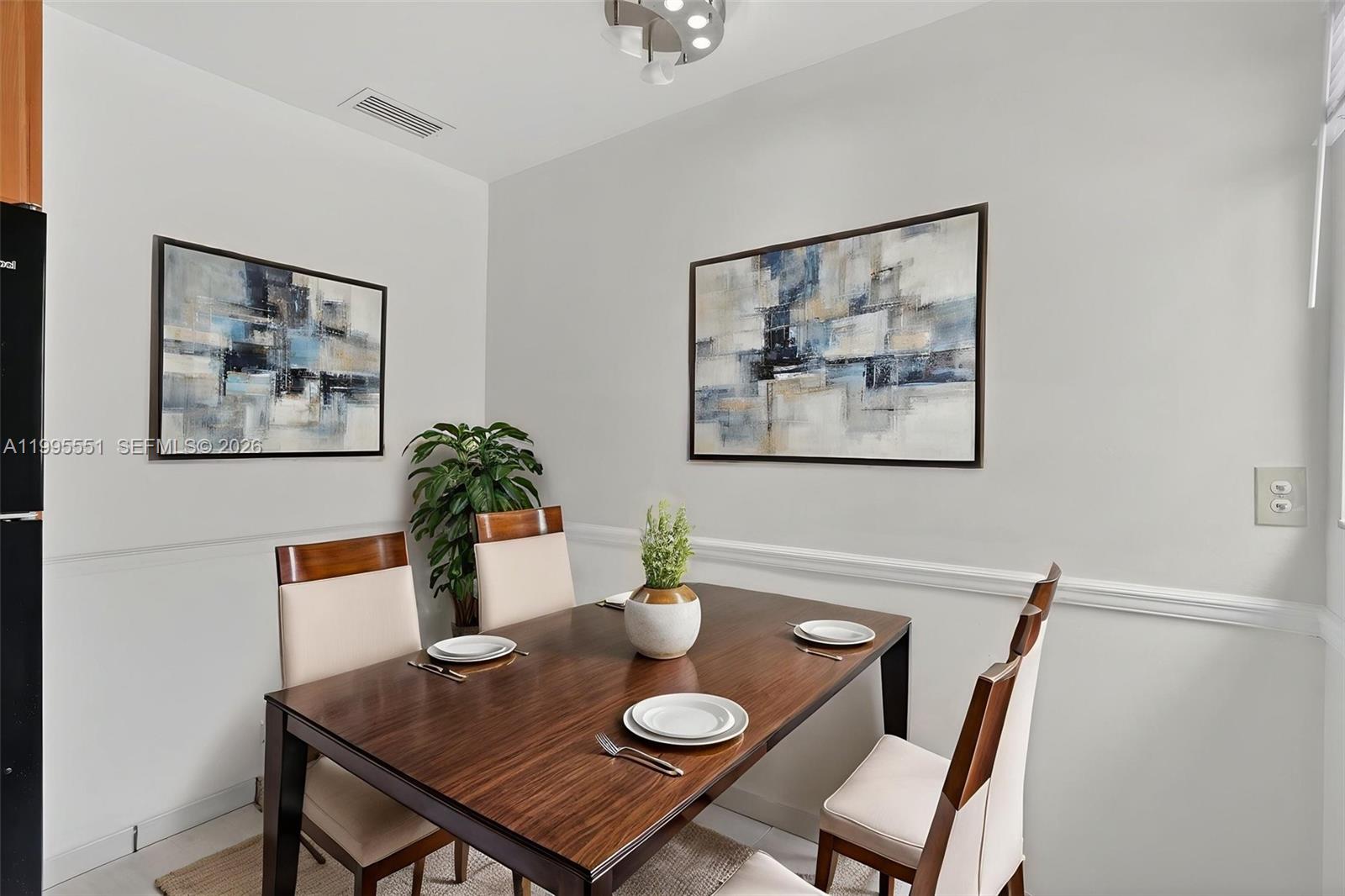 14722 Southwest 110th Terrace Miami, FL 33196 - Photo 11 of 37 a view of a dining room with furniture and chandelier