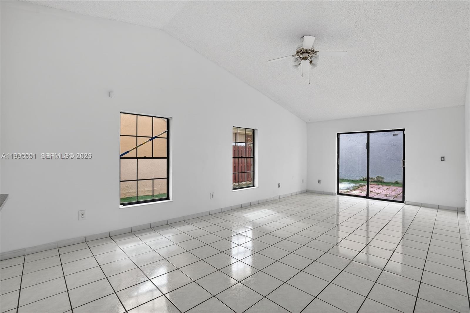 14722 Southwest 110th Terrace Miami, FL 33196 - Photo 12 of 37 an empty room with windows and ceiling fan