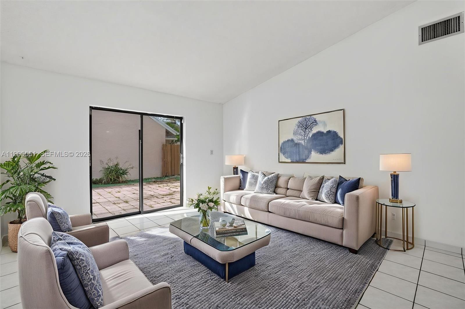 14722 Southwest 110th Terrace Miami, FL 33196 - Photo 15 of 37 a living room with furniture and a large window