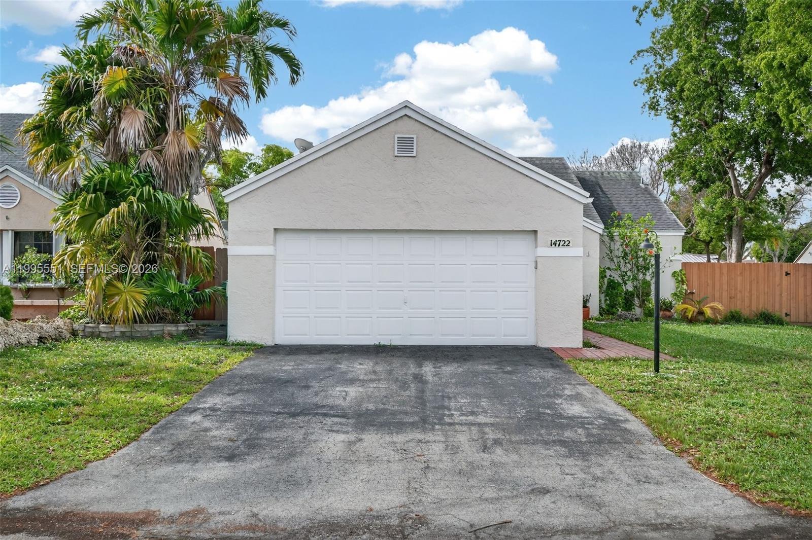 14722 Southwest 110th Terrace Miami, FL 33196 - Photo 2 of 37 a front view of house with yard and green space
