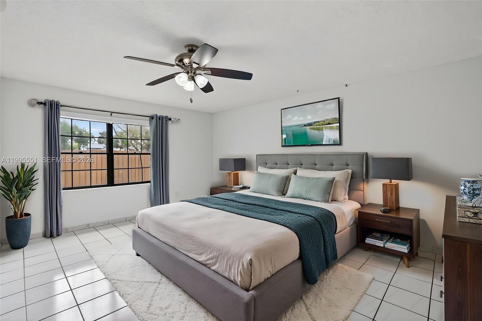 14722 Southwest 110th Terrace Miami, FL 33196 - Photo 23 of 37 a spacious bedroom with a bed and a window