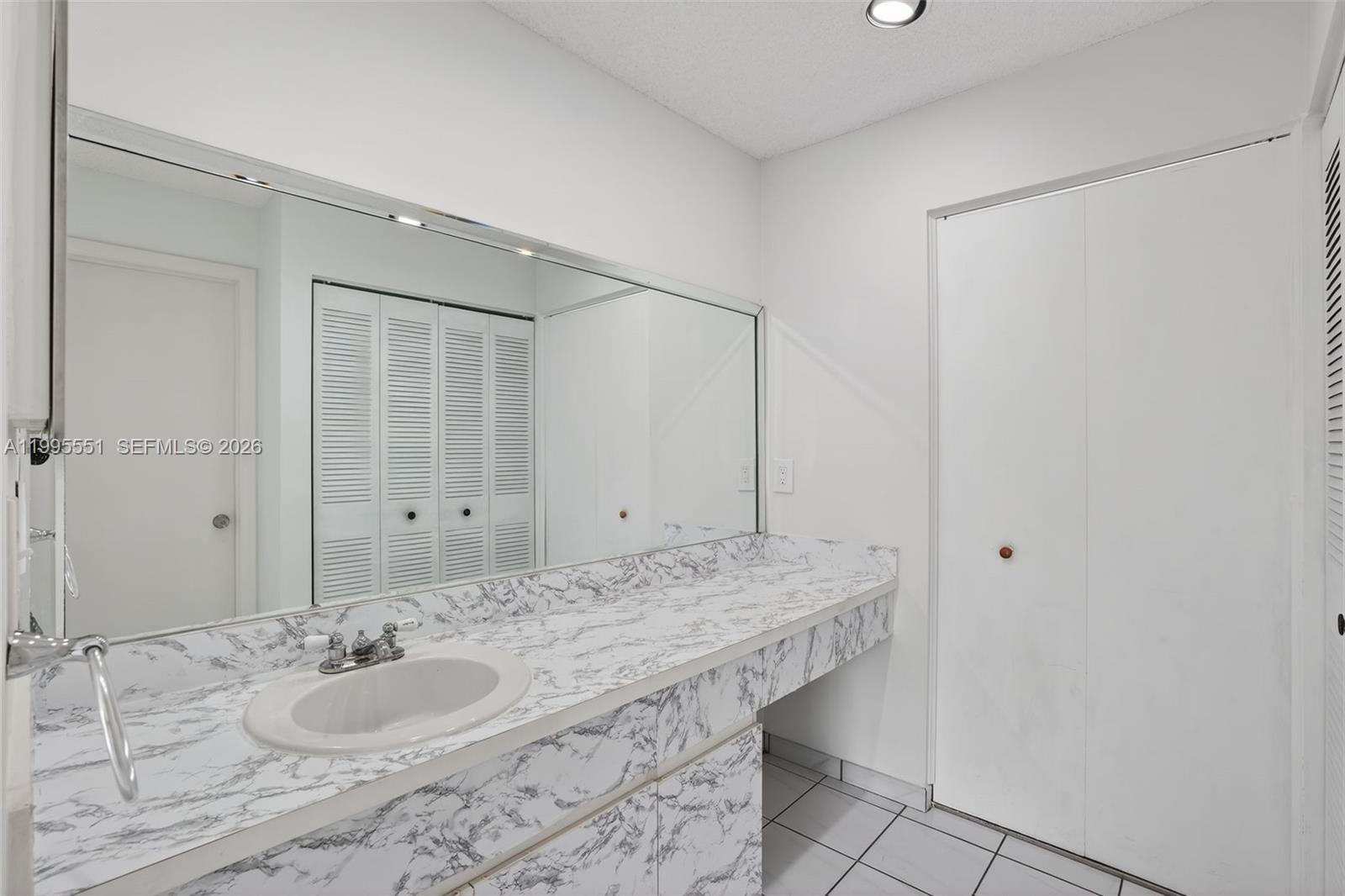 14722 Southwest 110th Terrace Miami, FL 33196 - Photo 25 of 37 a bathroom with a granite countertop sink and a mirror