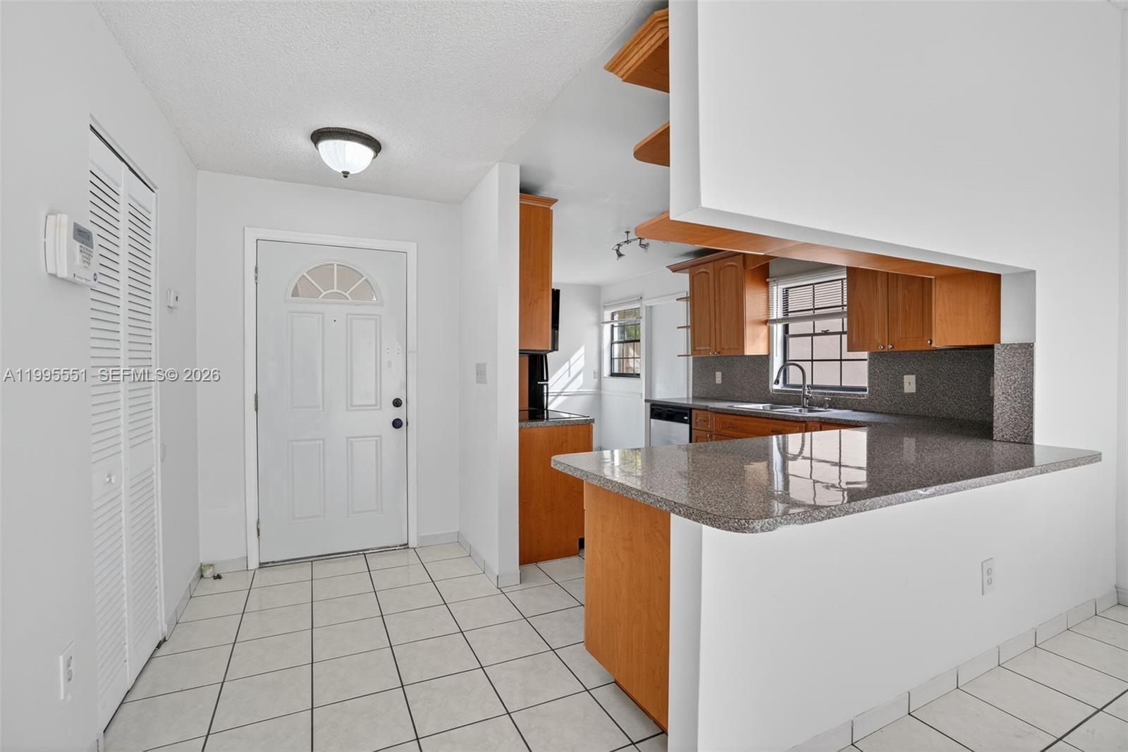 14722 Southwest 110th Terrace Miami, FL 33196 - Photo 6 of 37 a kitchen with stainless steel appliances granite countertop a sink and a refrigerator