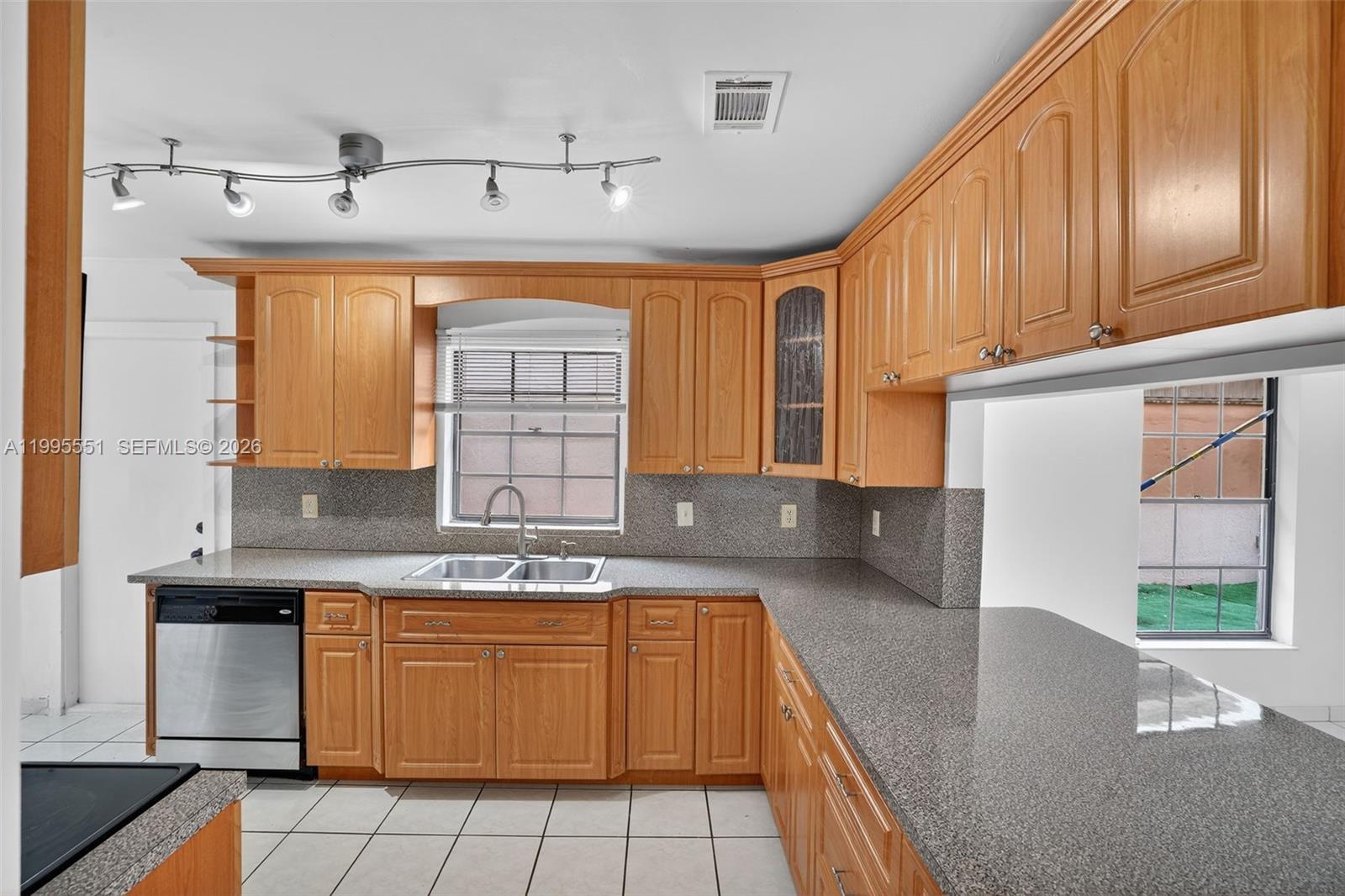 14722 Southwest 110th Terrace Miami, FL 33196 - Photo 7 of 37 a kitchen with stainless steel appliances granite countertop a sink stove and cabinets