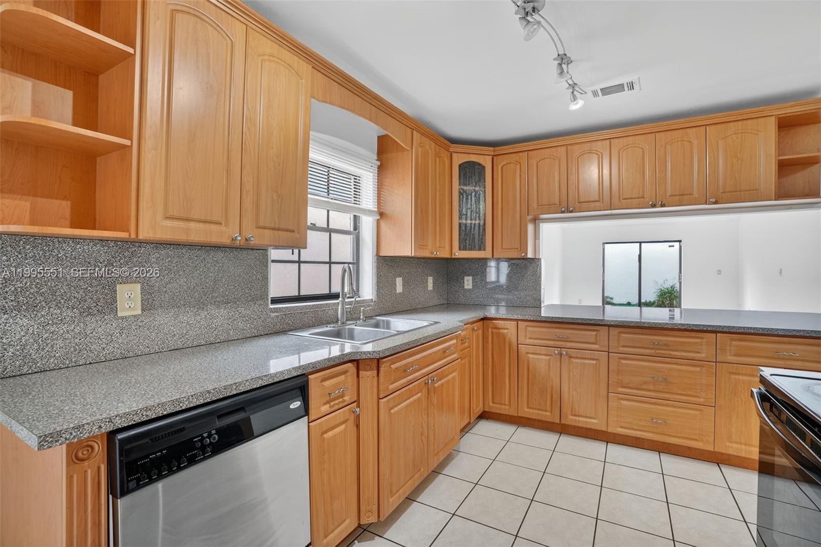 14722 Southwest 110th Terrace Miami, FL 33196 - Photo 8 of 37 a kitchen with stainless steel appliances granite countertop a sink and cabinets