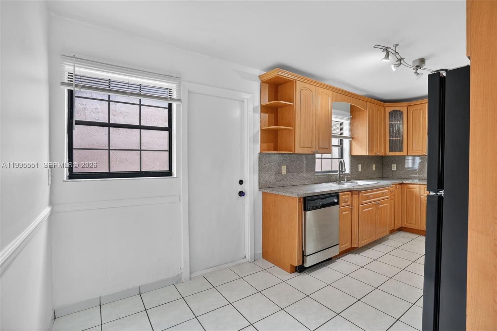 14722 Southwest 110th Terrace Miami, FL 33196 - Photo 10 of 37 a kitchen with stainless steel appliances granite countertop a stove a sink and a refrigerator