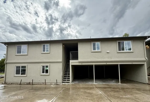 a front view of a house with parking space