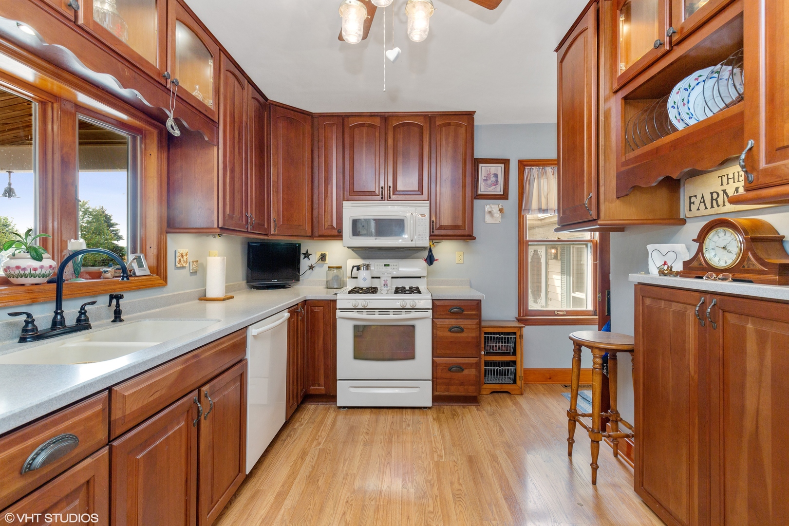 28573 Moose Range Road Sycamore, IL 60178 - Photo 26 of 52 a kitchen with stainless steel appliances a stove a sink dishwasher and cabinets with wooden floor