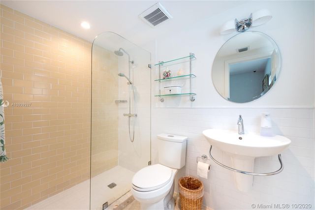 a bathroom with a toilet sink and shower