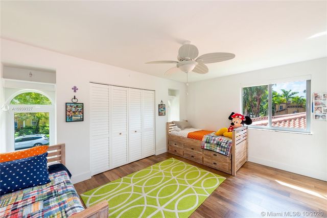 a bedroom with furniture and a large window