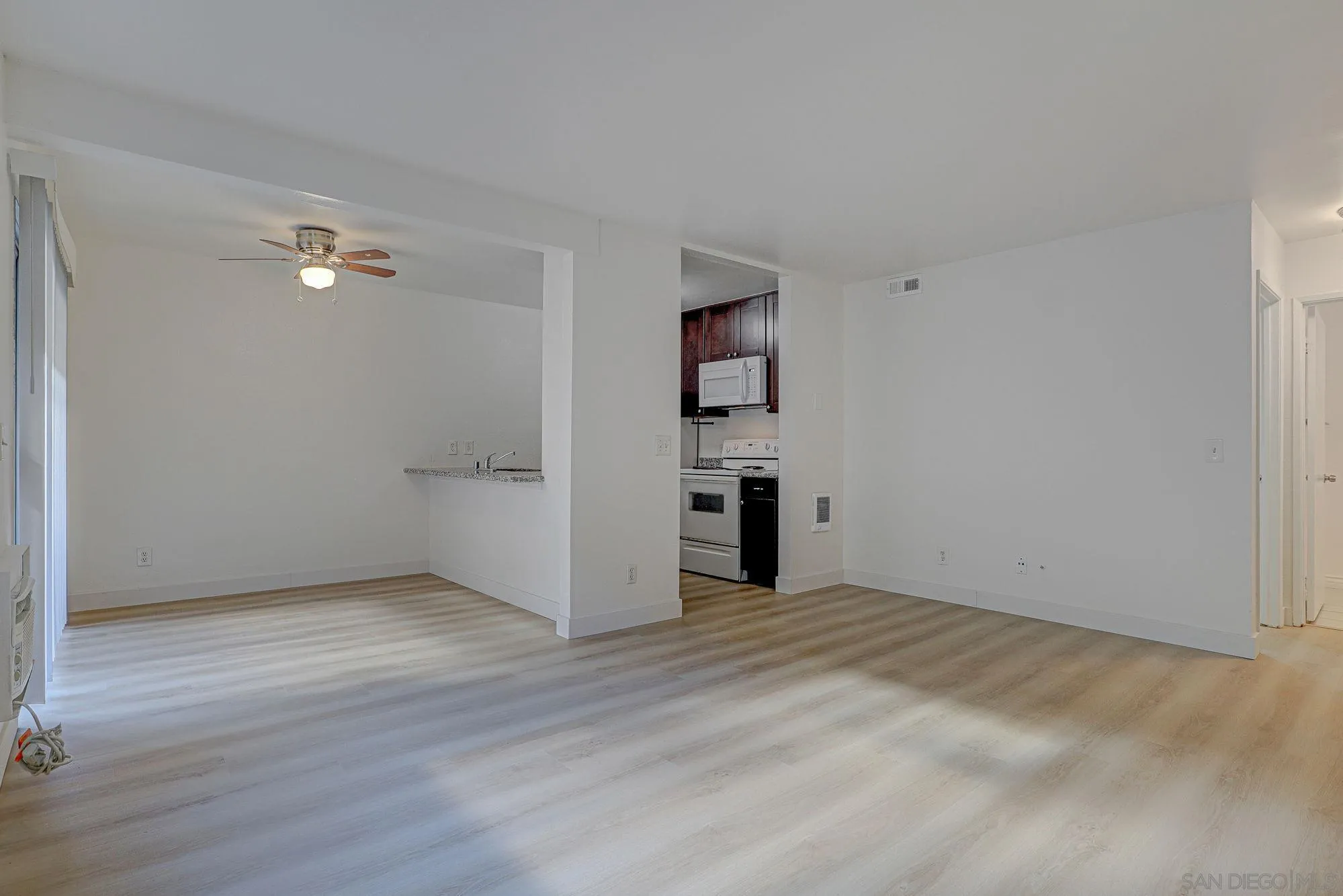 6902 Mission Gorge Road San Diego, CA 92120 - Photo 2 of 14 wooden floor in an empty room with a window