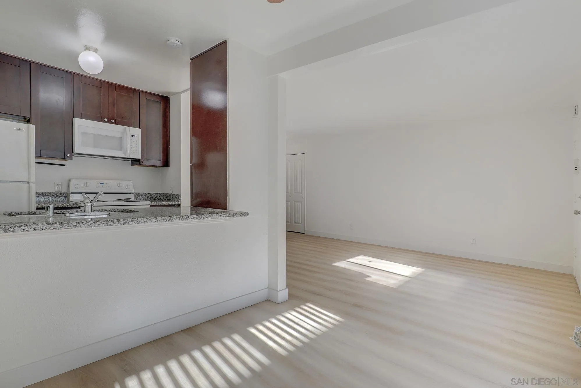 6902 Mission Gorge Road San Diego, CA 92120 - Photo 3 of 14 a view of kitchen with granite countertop cabinets and refrigerator