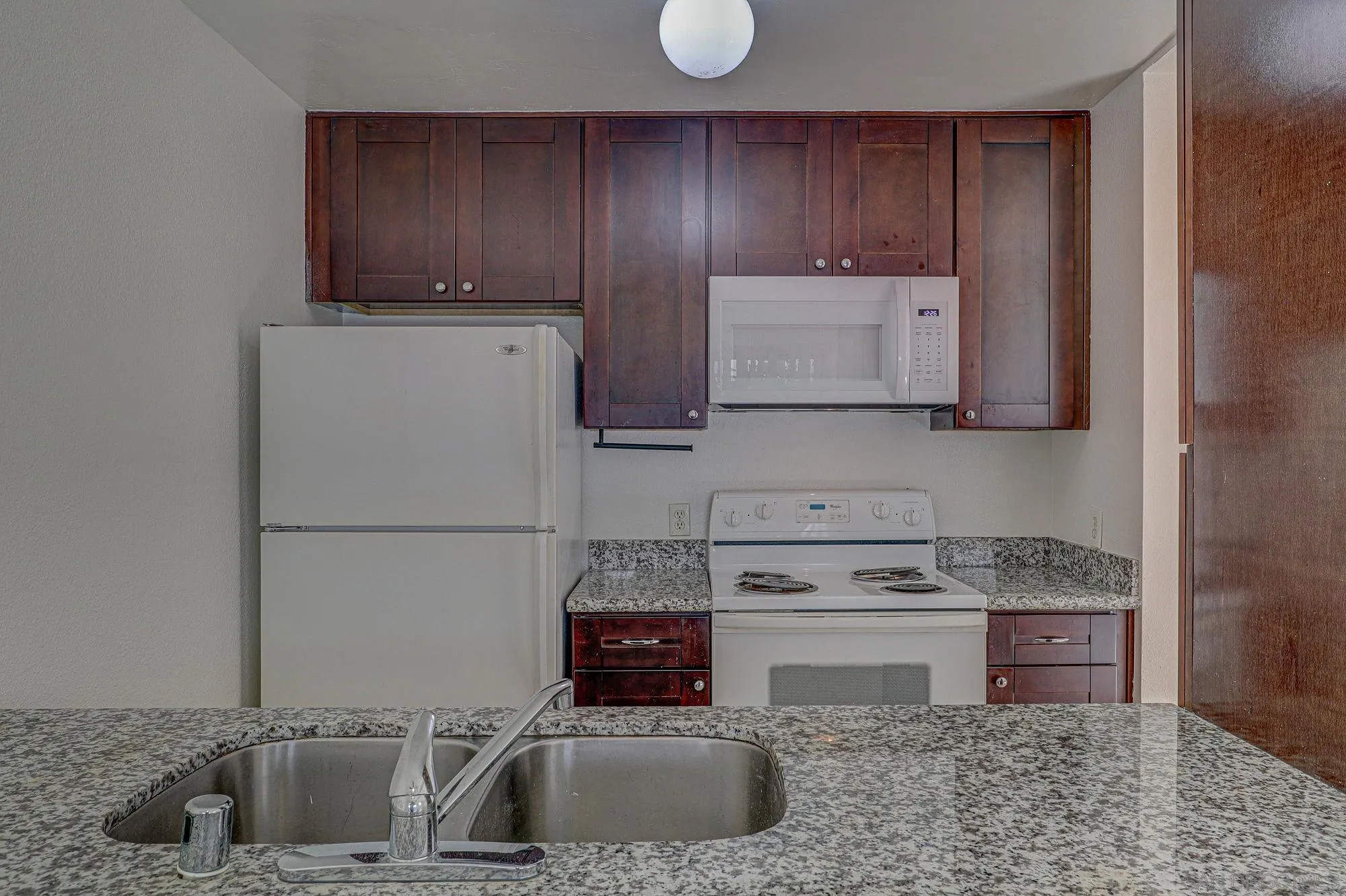 6902 Mission Gorge Road San Diego, CA 92120 - Photo 6 of 14 a kitchen with stainless steel appliances granite countertop a sink stove and refrigerator