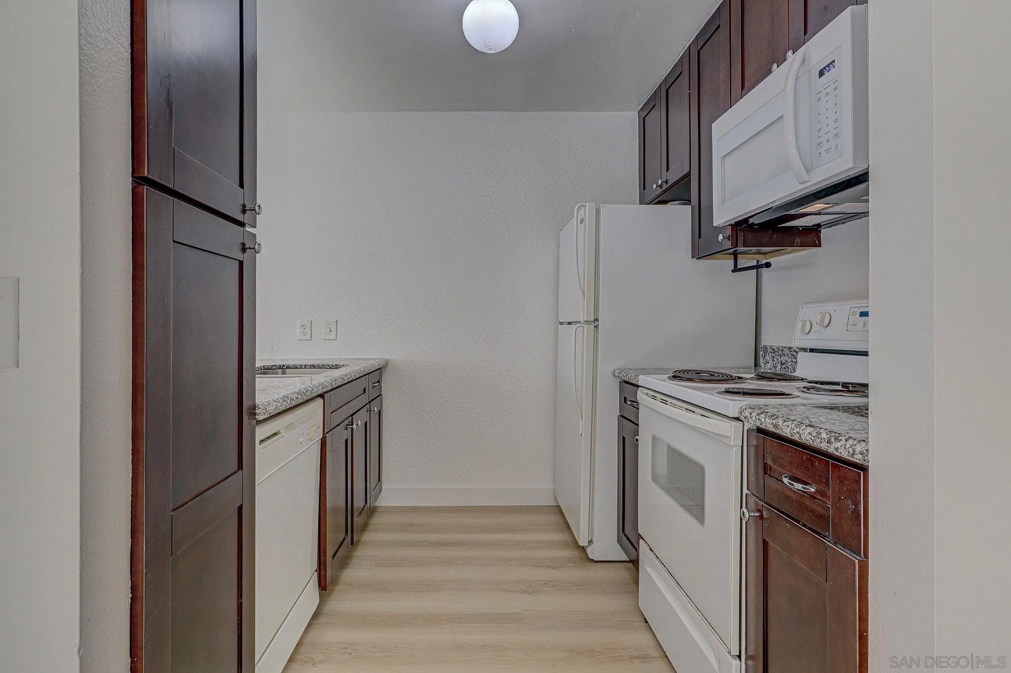 6902 Mission Gorge Road San Diego, CA 92120 - Photo 8 of 14 a kitchen with stainless steel appliances granite countertop a refrigerator and a stove