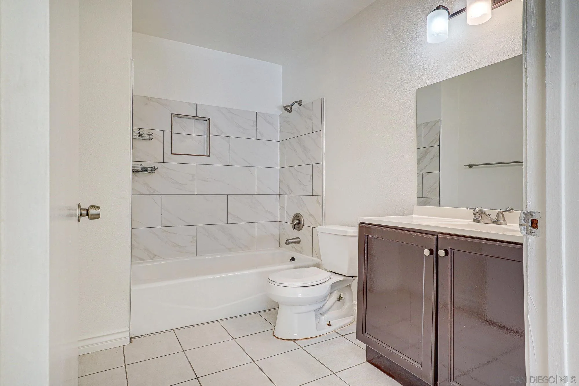 6902 Mission Gorge Road San Diego, CA 92120 - Photo 9 of 14 a bathroom with a bathtub toilet and sink