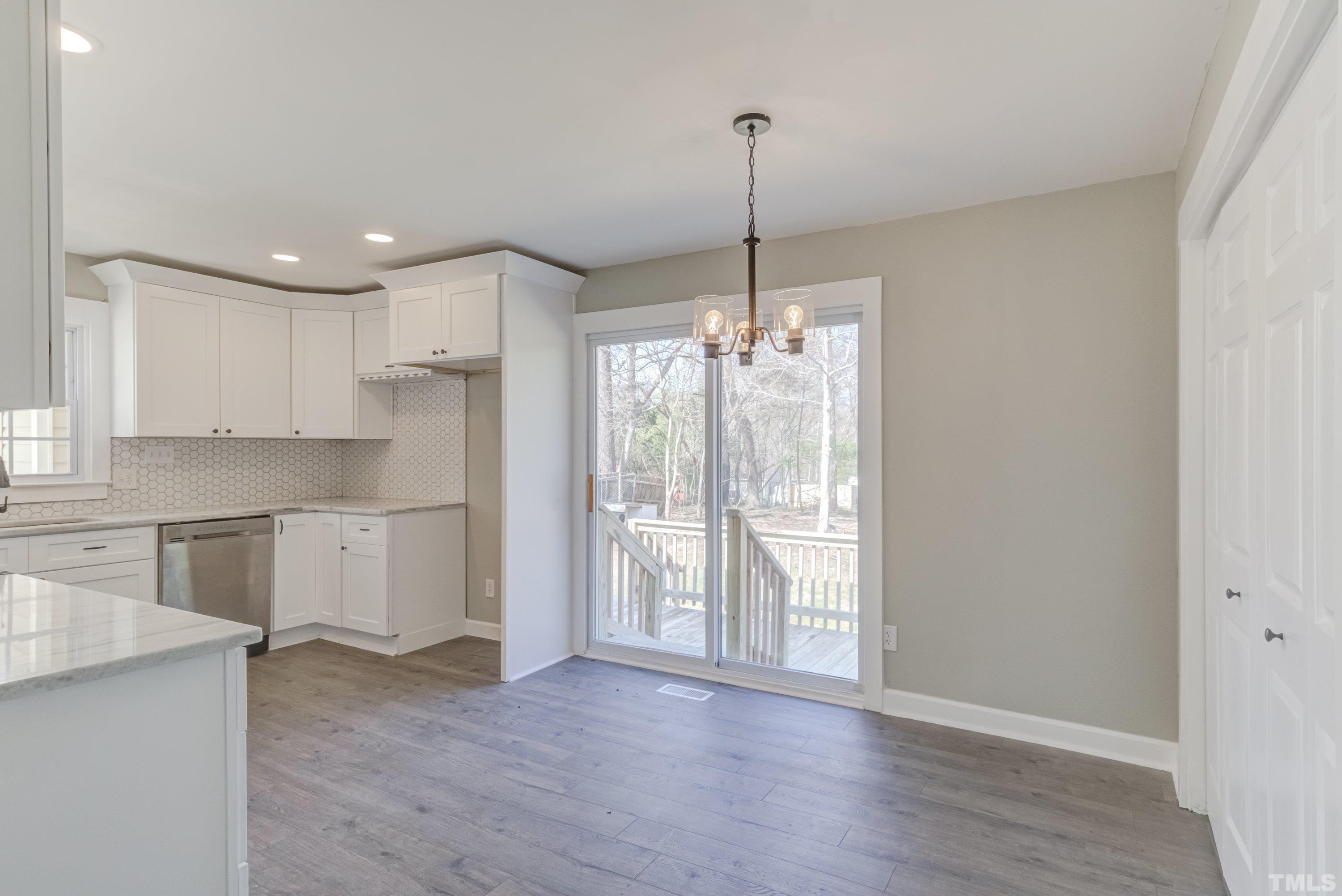 5809 Neuse Street Raleigh, NC 27610 - Photo 16 of 19 a view of a kitchen with a sink cabinets and wooden floor