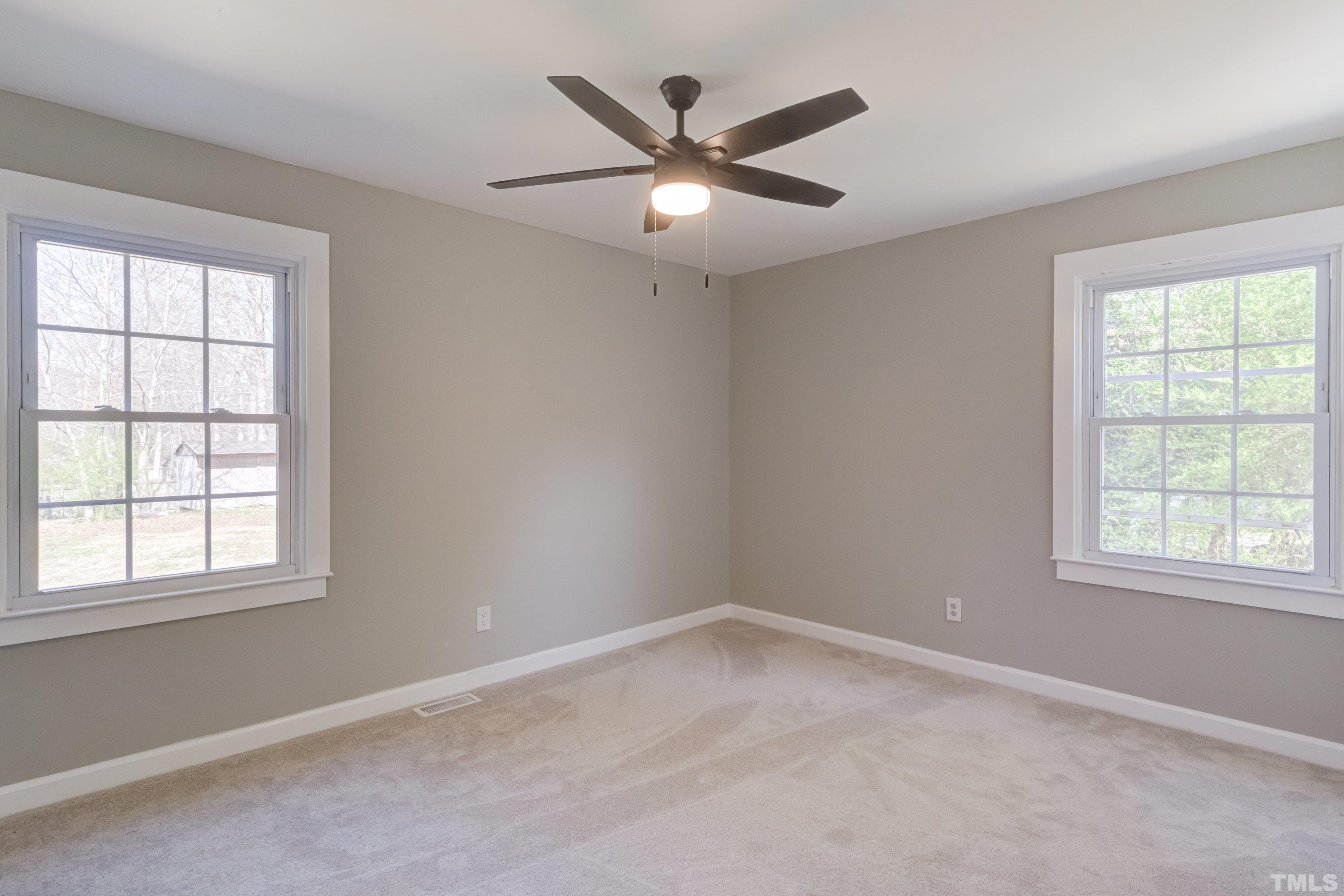 5809 Neuse Street Raleigh, NC 27610 - Photo 17 of 19 an empty room with a window and a ceiling fan