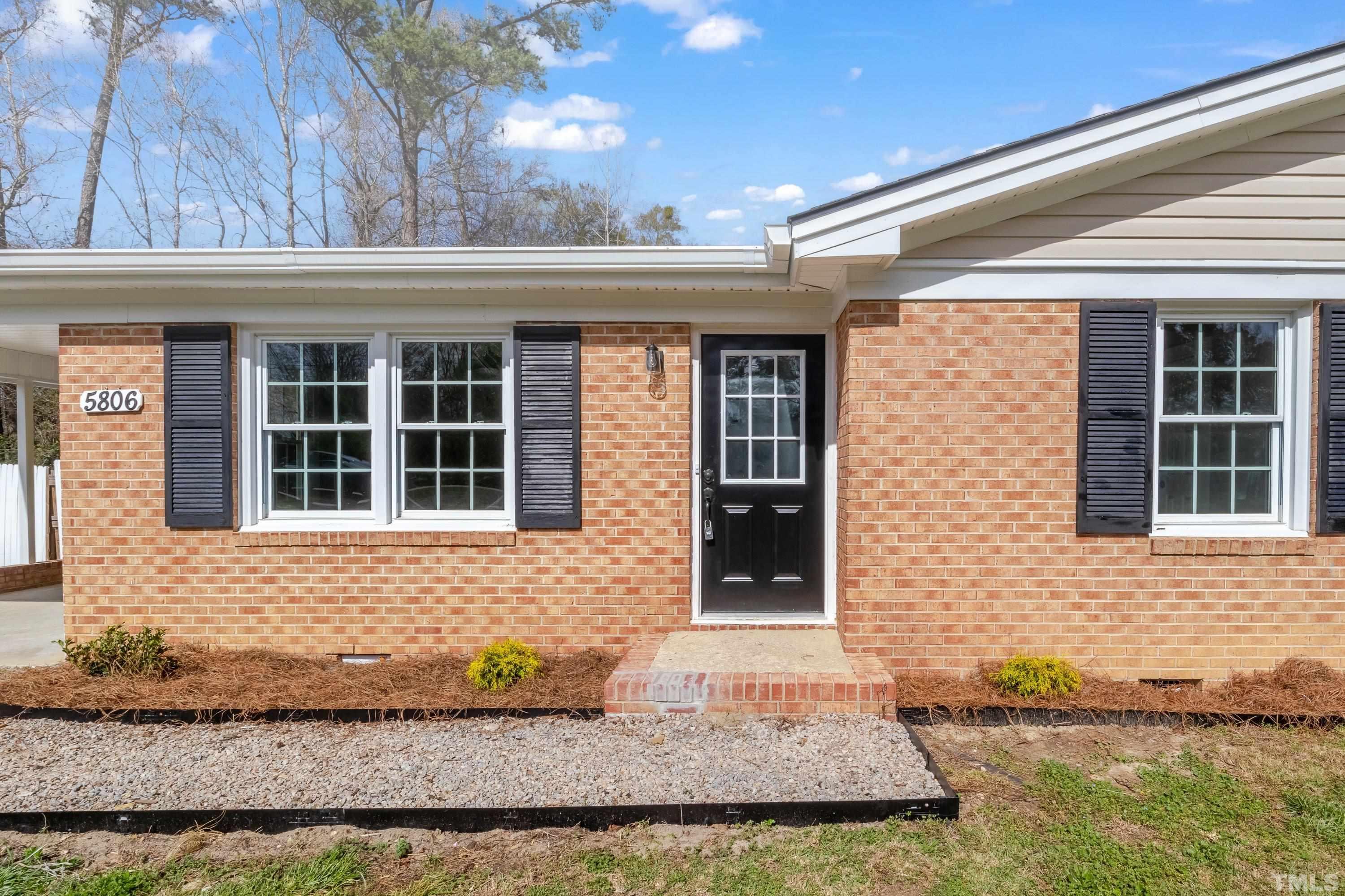5809 Neuse Street Raleigh, NC 27610 - Photo 2 of 19 a front view of a house with a yard