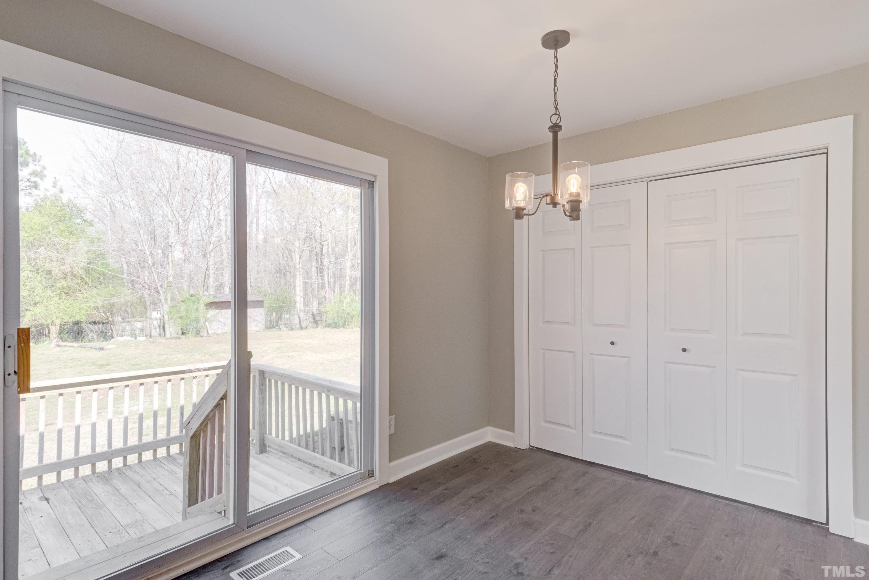 5809 Neuse Street Raleigh, NC 27610 - Photo 8 of 19 a view of a room with window wooden floor and outdoor space