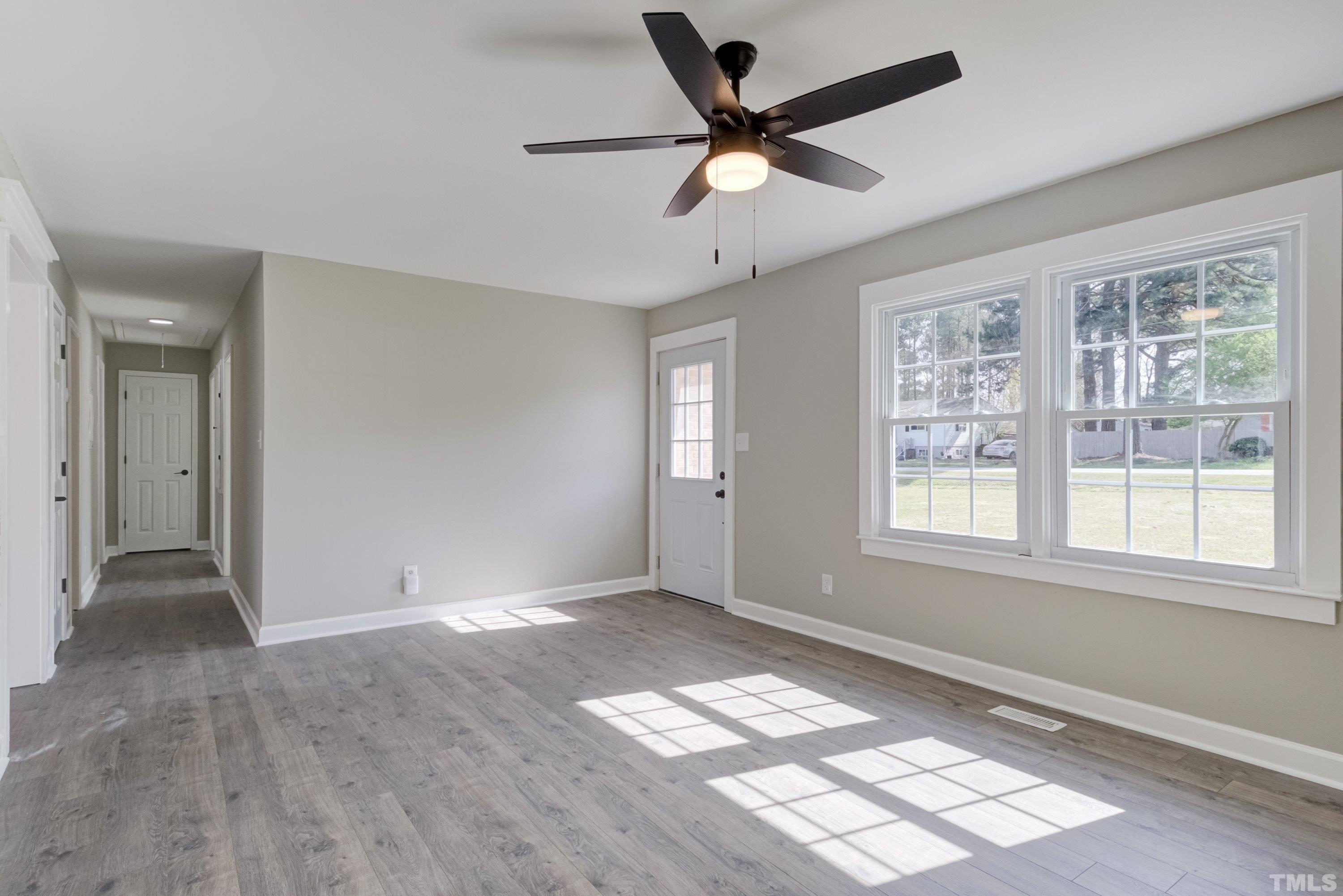 5809 Neuse Street Raleigh, NC 27610 - Photo 10 of 19 wooden floor in an empty room with a window