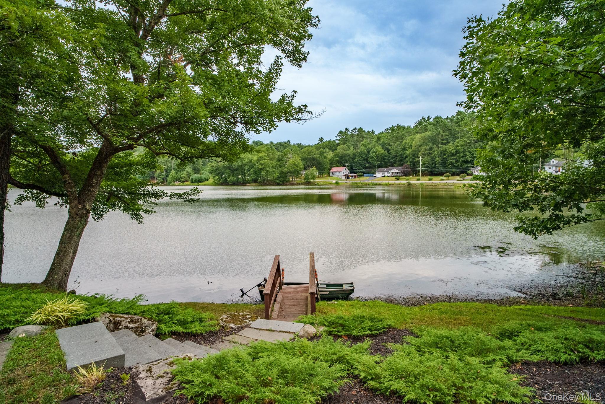 an aerial view of a house with a yard and lake view
