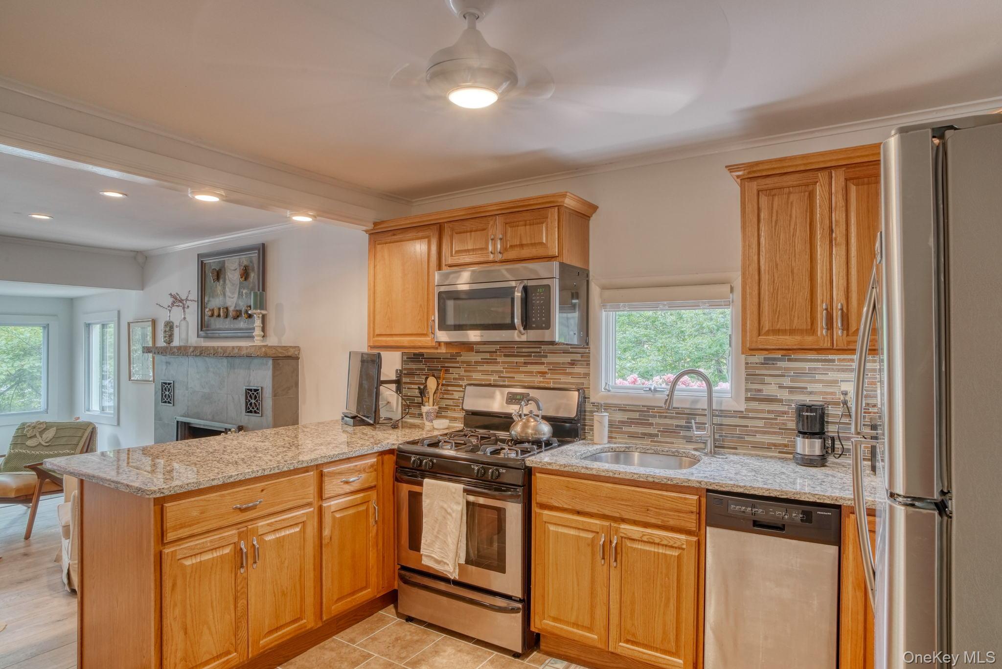 2 Bodine Lake Road Yulan, NY 12792 - Photo 12 of 32 a kitchen with stainless steel appliances granite countertop a stove a sink and a refrigerator