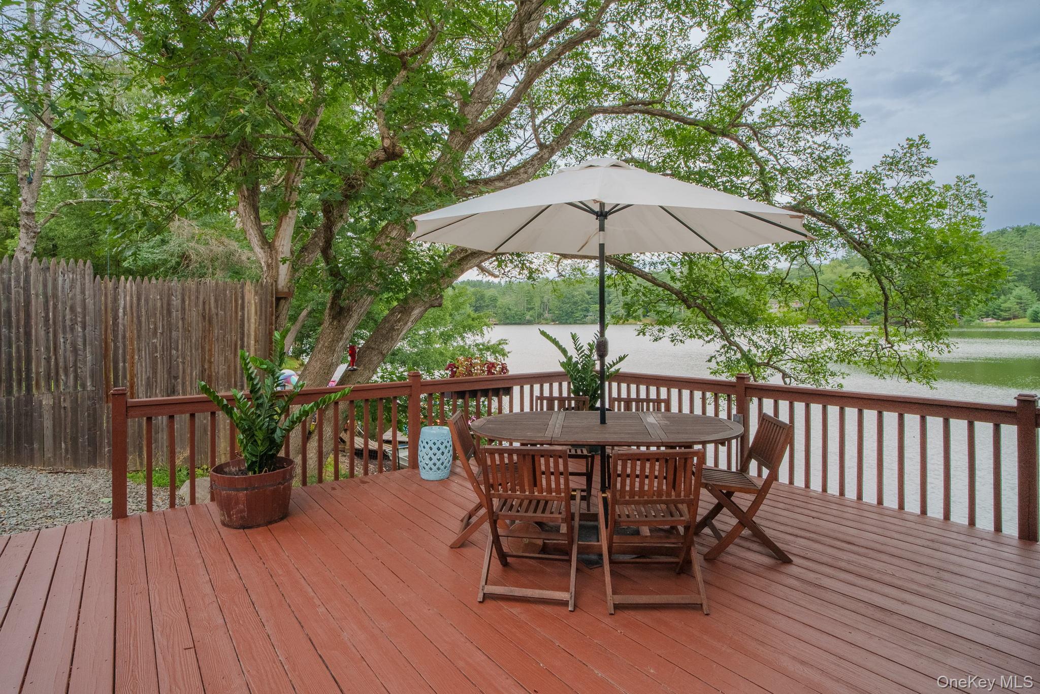 2 Bodine Lake Road Yulan, NY 12792 - Photo 6 of 32 a view of balcony with outdoor seating and wooden floor