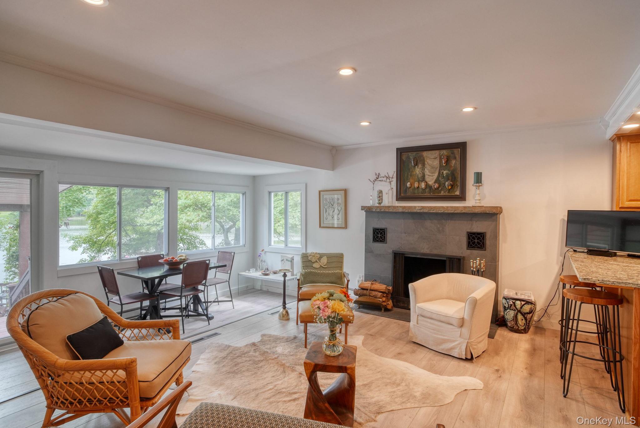 2 Bodine Lake Road Yulan, NY 12792 - Photo 10 of 32 a living room with furniture a fireplace and a large window