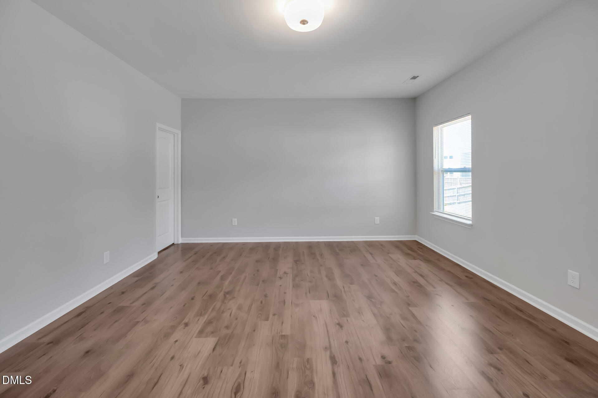 5406 Ripplebrook Drive Durham, NC 27712 - Photo 23 of 37 an empty room with wooden floor and windows
