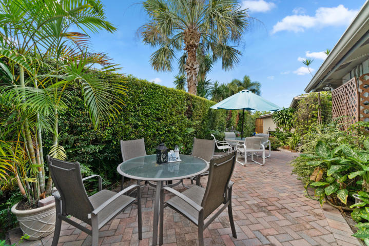 2016 Joy-Rene Lane, Unit 2 North Palm Beach, FL 33408 - Photo 12 of 13 a view of a backyard with furniture and a garden