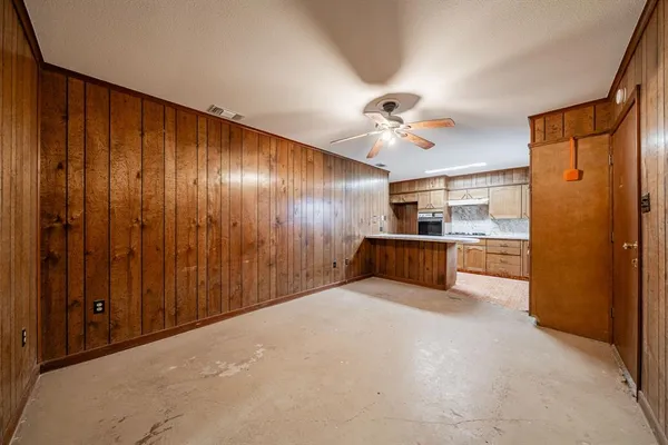 a view of an empty room with a kitchen
