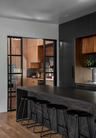 a kitchen with stainless steel appliances kitchen island granite countertop a sink a stove and cabinets