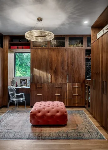 a bedroom with furniture and a large window