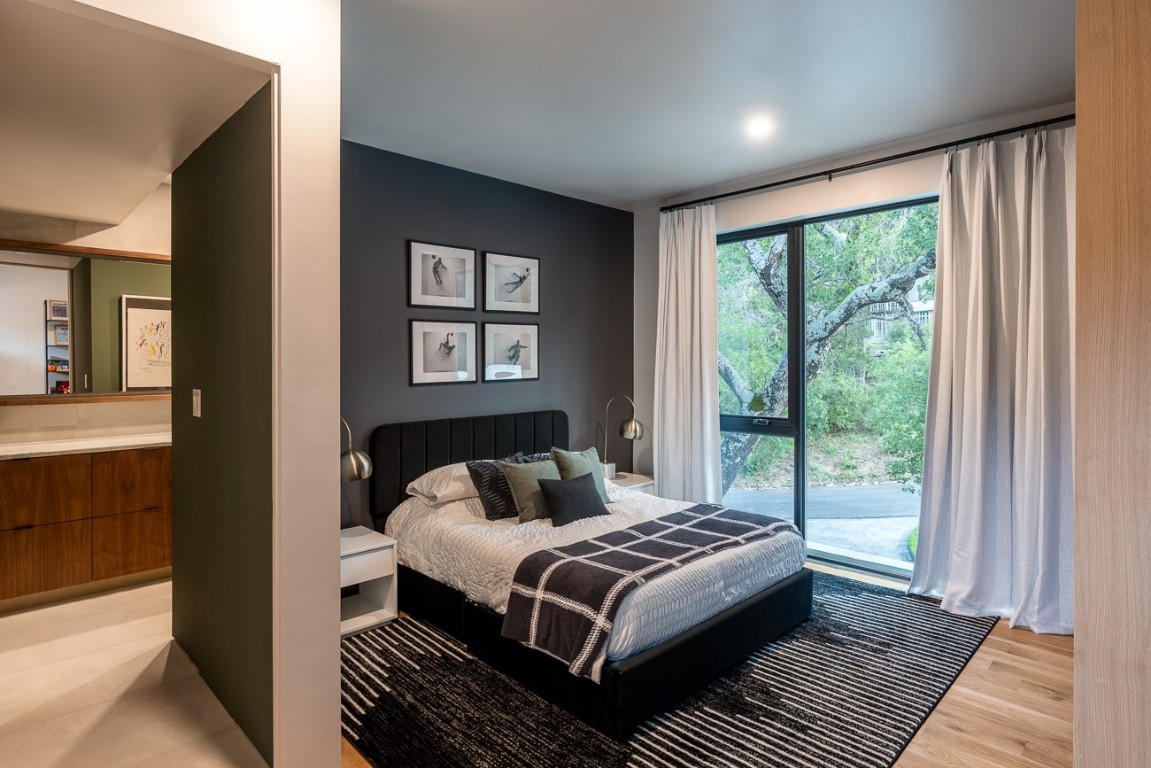 1001 Madrone Road West Lake Hills, TX 78746 - Photo 30 of 40 a bedroom with a large bed and a window