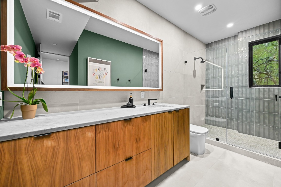 1001 Madrone Road West Lake Hills, TX 78746 - Photo 31 of 40 a bathroom with a granite countertop sink and a mirror