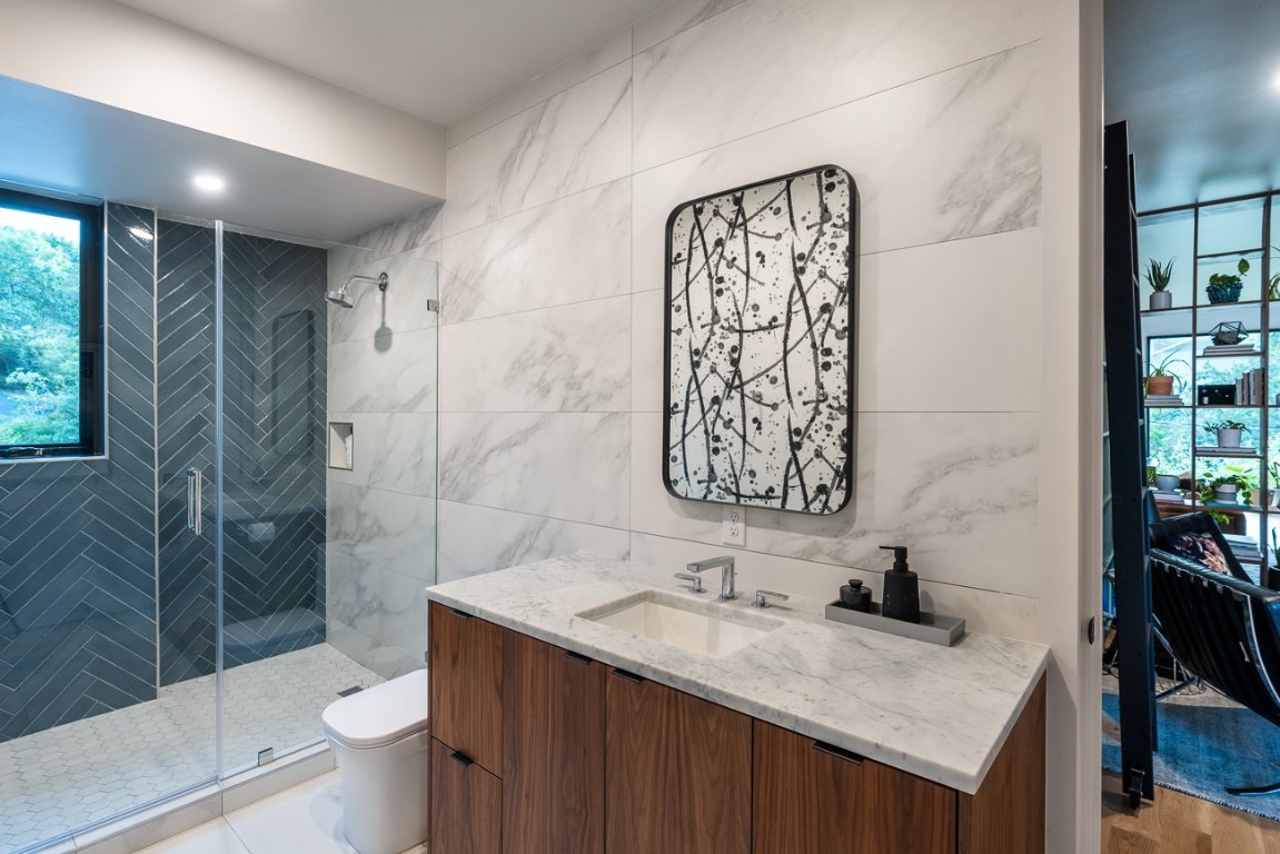1001 Madrone Road West Lake Hills, TX 78746 - Photo 33 of 40 a bathroom with a granite countertop sink toilet and shower