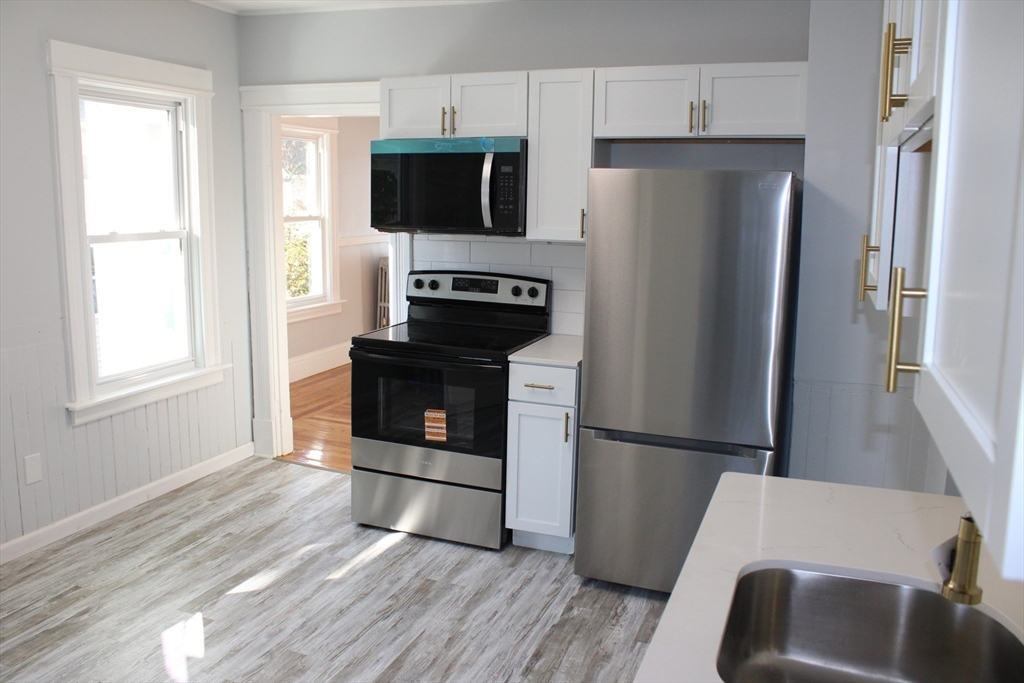 a kitchen with a refrigerator stove and microwave