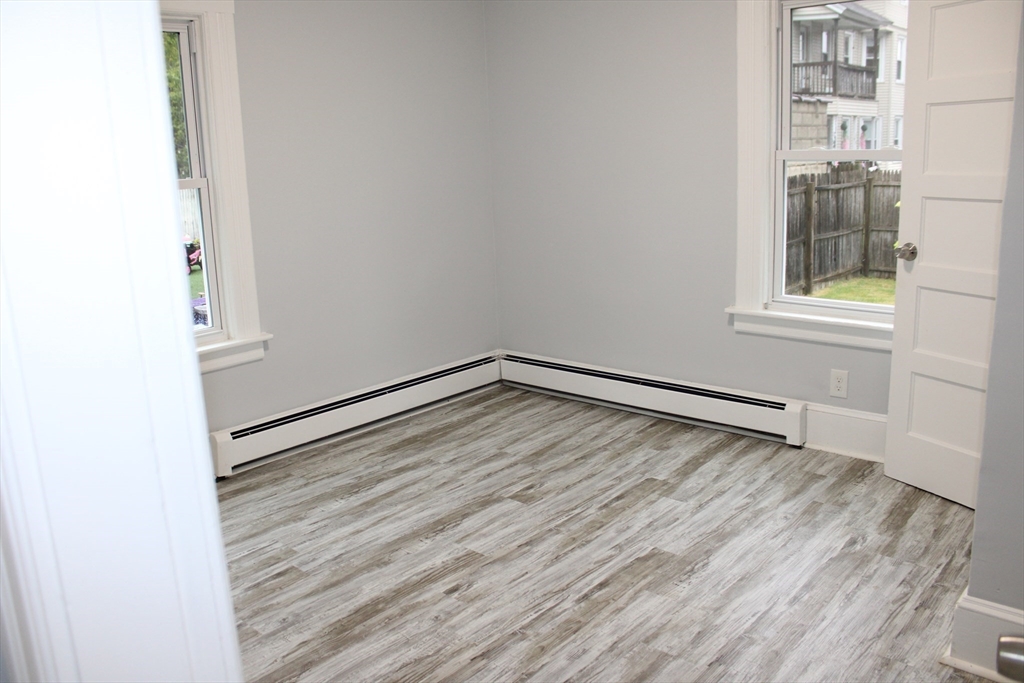 25 Malden Street Springfield, MA 01108 - Photo 11 of 25 a view of an empty room with wooden floor and a window