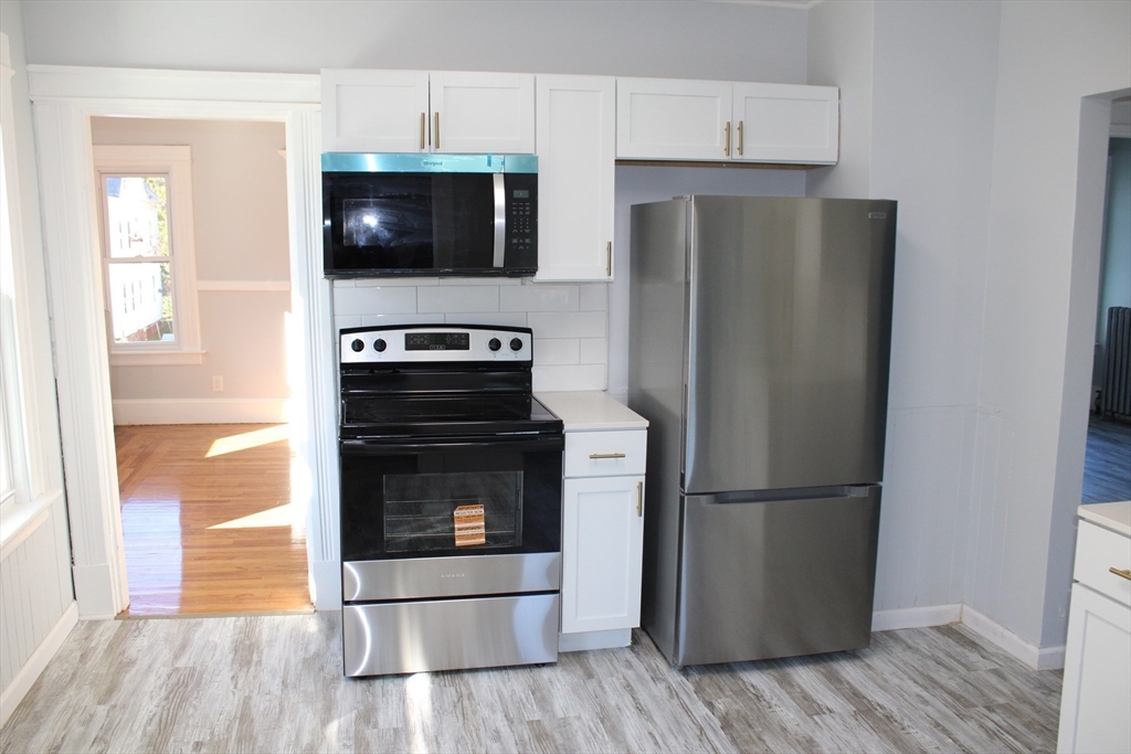 25 Malden Street Springfield, MA 01108 - Photo 14 of 25 a kitchen with a refrigerator stove and microwave