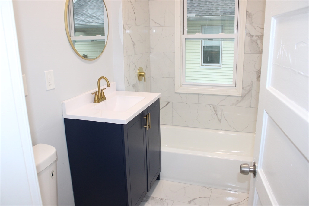 25 Malden Street Springfield, MA 01108 - Photo 15 of 25 a bathroom with a sink and a mirror