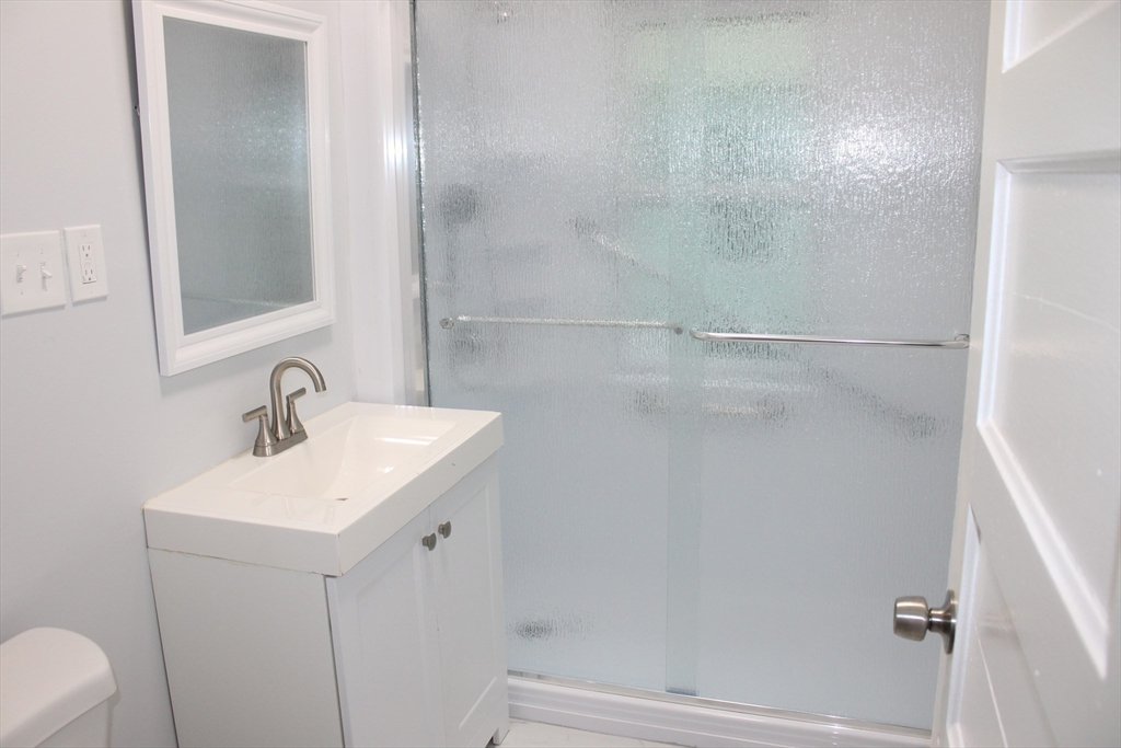 25 Malden Street Springfield, MA 01108 - Photo 10 of 25 a bathroom with a sink a toilet and shower