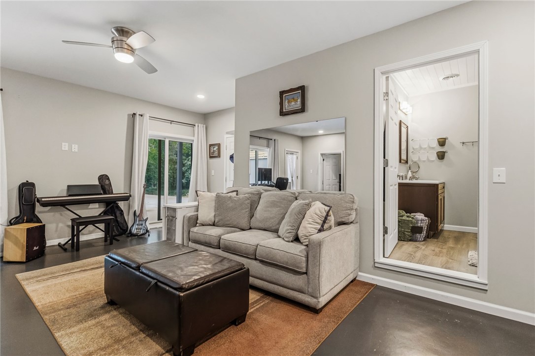 641 Lands End Road Seneca, SC 29678 - Photo 21 of 39 A well-lit family room offers direct access to the outdoors, fostering an open and inviting atmosphere.